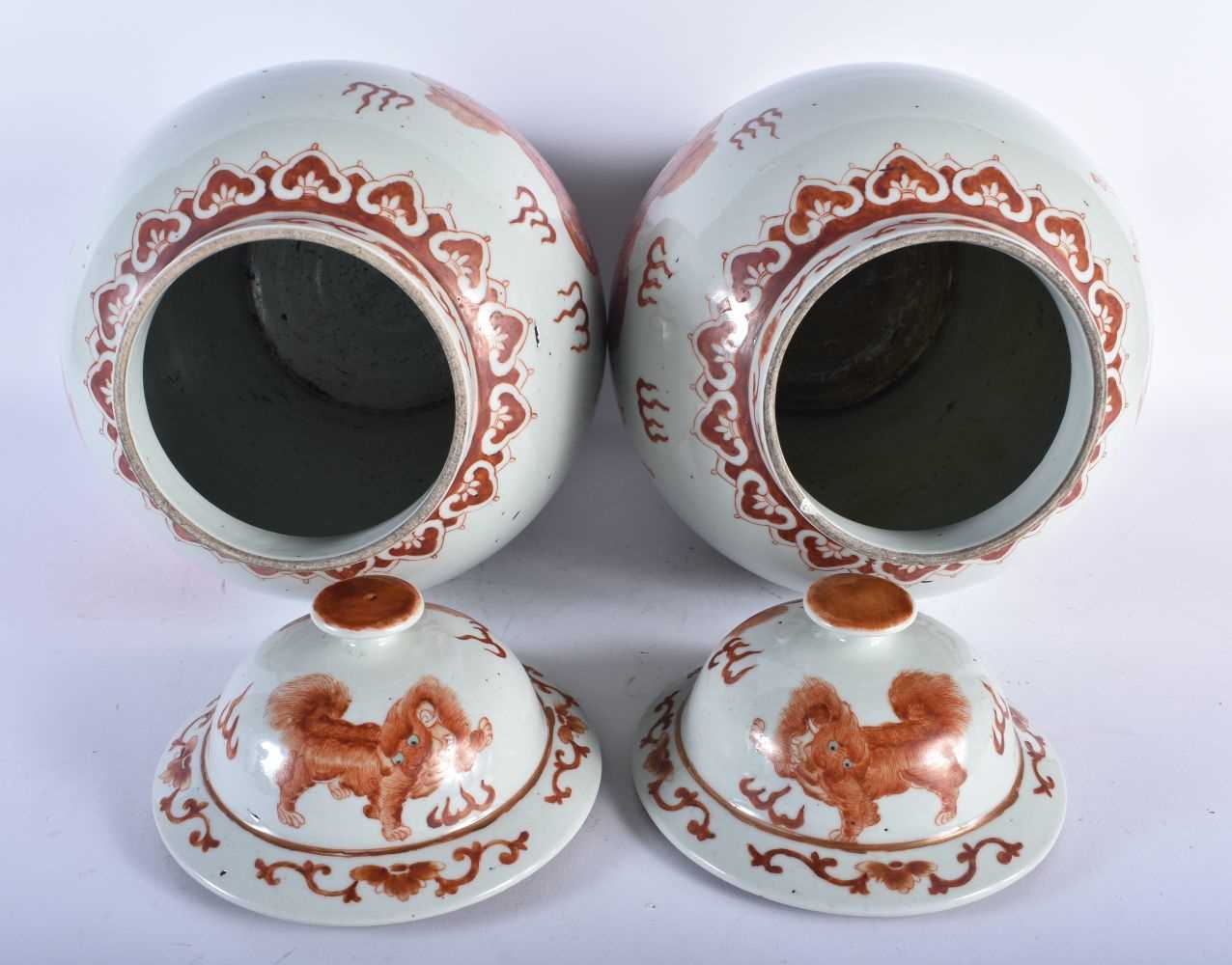 A LARGE PAIR OF CHINESE QING DYNASTY IRON RED PAINTED GINGER JARS AND COVERS painted with buddhistic - Image 3 of 26