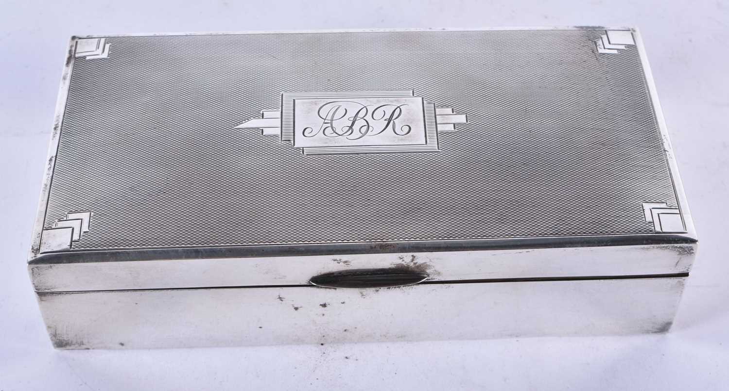 A Silver Cigarette Box with Engine Turned Decoration and wooden interior by Saunders & Mackenzie.