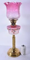 A LARGE ANTIQUE BRASS AND PINK GLASS OIL LAMP. 60 cm high.