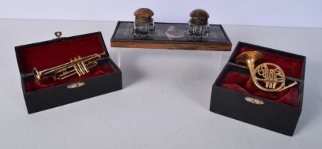 Two cased miniature brass wind instruments ,French horn and a Trumpet together with a ink stand 21 x