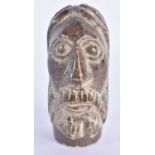 A 19TH CENTURY MIDDLE EASTERN CARVED STONE HEAD OF A SAINT. 8 cm x 3.5 cm.