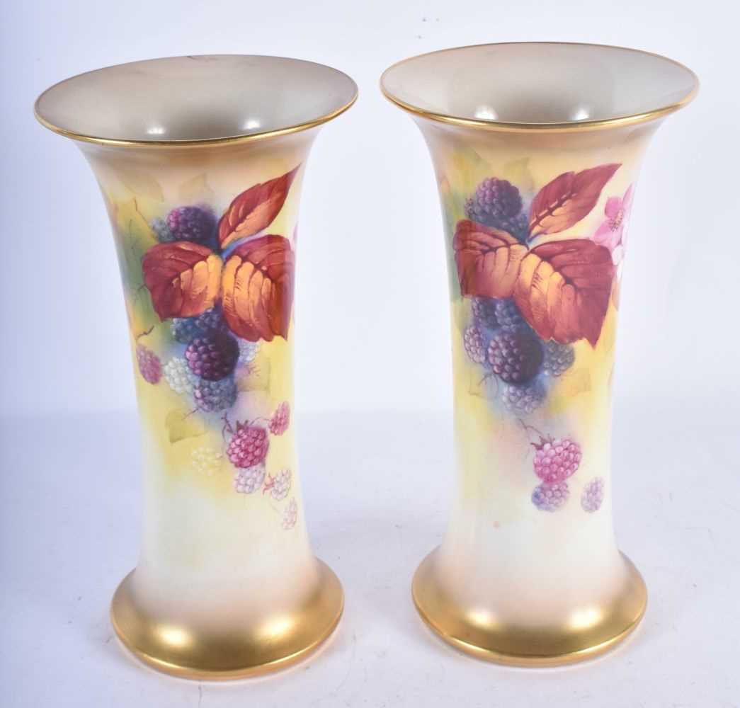 A PAIR OF ROYAL WORCESTER BLUSH IVORY VASES by Kitty Blake. 19 cm high.