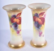 A PAIR OF ROYAL WORCESTER BLUSH IVORY VASES by Kitty Blake. 19 cm high.