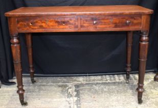 A 19th Century two drawer writing table with castors fitted to tapering legs 76 x 106 x 54.5 cm.