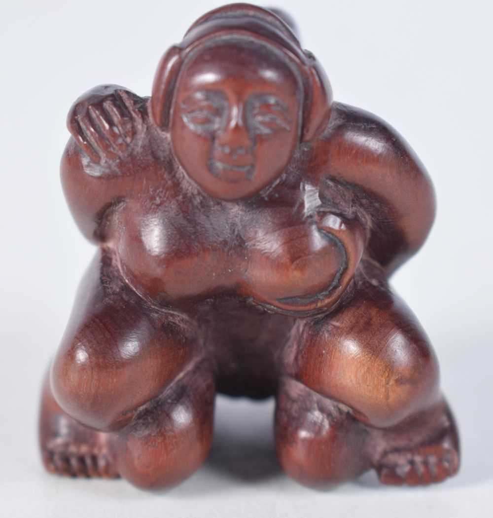 A Carved Hardwood Erotic Netsuke. 4.7cm x 4.1cm x 3.7cm, weight 27g