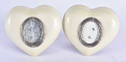 A PAIR OF VINTAGE SILVER AND ENAMEL HEART SHAPED PHOTOGRAPH FRAMES. 205 grams overall. 9.5 cm x 8.