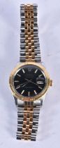 A GOLD AND STAINLESS STEEL BLACK DIAL WRISTWATCH. 3.75 cm wide inc crown.