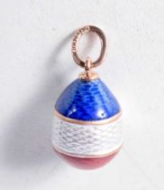 A Continental Gold and Enamel Egg Pendant. Stamped 56. 2 cm x 1.2 cm, weight 2.5g