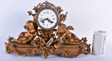 A LARGE 19TH CENTURY FRENCH BRONZE MANTEL CLOCK formed with a central drum encased by two putti.