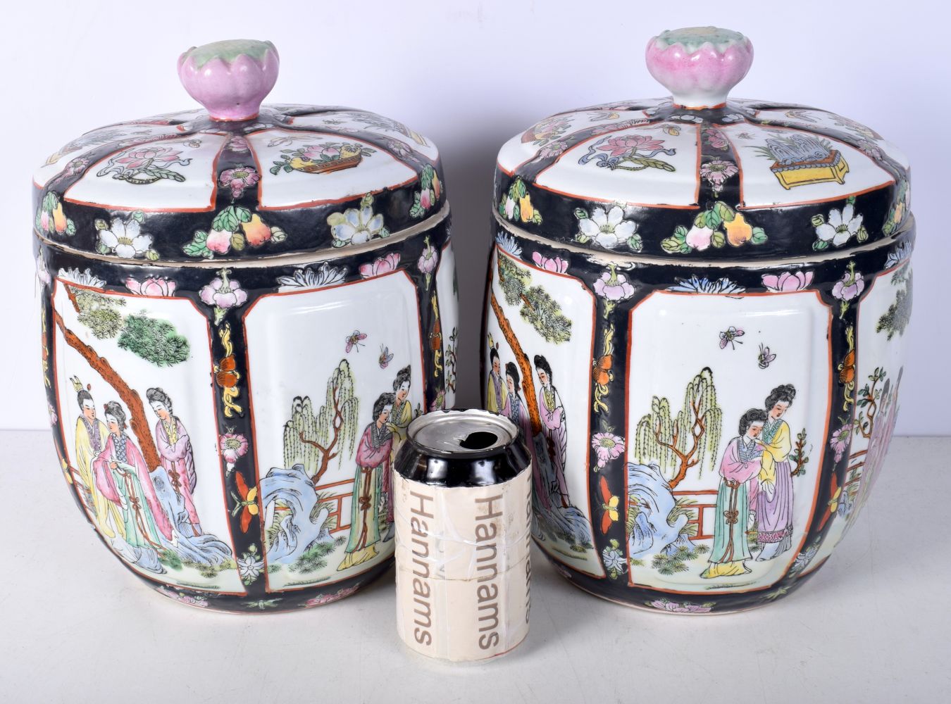 A pair of Chinese porcelain polychrome lidded jars decorated with figures in panels 28cm (2).