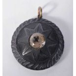 AN ANTIQUE BOG OAK PENDANT. 13.5 grams. 4 cm diameter.