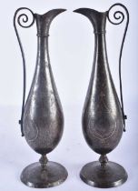 A PAIR OF 19TH CENTURY ISLAMIC PERSIAN MIDDLE EASTERN STEEL EWERS inlaid with gold and silver