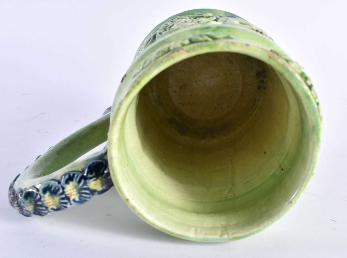 A RARE ANTIQUE GREEN GLAZED WHIELDON TYPE MAJOLICA MUG decorated in relief with figures. 14 cm x - Image 5 of 6