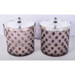 A pair of silver plated and glass biscuit barrels 15 cm (2).