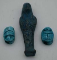 AN EGYPTIAN FAIENCE PHAROAH together with two scarab beetles. Largest 5.5 cm high. (3)