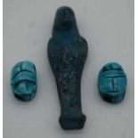 AN EGYPTIAN FAIENCE PHAROAH together with two scarab beetles. Largest 5.5 cm high. (3)