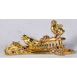 An Antique Yellow Metal Brooch set with Diamonds and Rubies. 3.9cm x 1.9cm, weight 9.5g