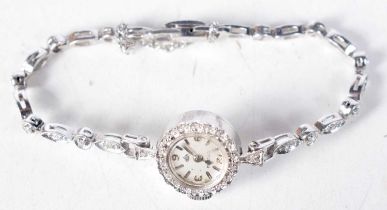 A 14 Carat White Gold Ladies Cocktail Watch set with diamonds. Stamped 14K. Length 16cm, Dial 1.