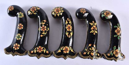 A SET OF FIVE MIDDLE EASTERN QAJAR LACQUER HARDSTONE DAGGER HANDLES overlaid with foliage and vines.