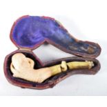 An Antique Cased Meerschaum Pipe, Bowl carved as a Claw with damaged Stem. Case 8.5 cm x 3.6 cm