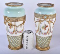 A PAIR OF LATE 19TH CENTURY FRENCH SEVRES STYLE PARIS PORCELAIN VASES overlaid with gilt metal