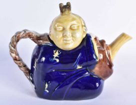 AN ANTIQUE MAJOLICA TEAPOT AND COVER formed as a Chinaman. 19 cm wide.