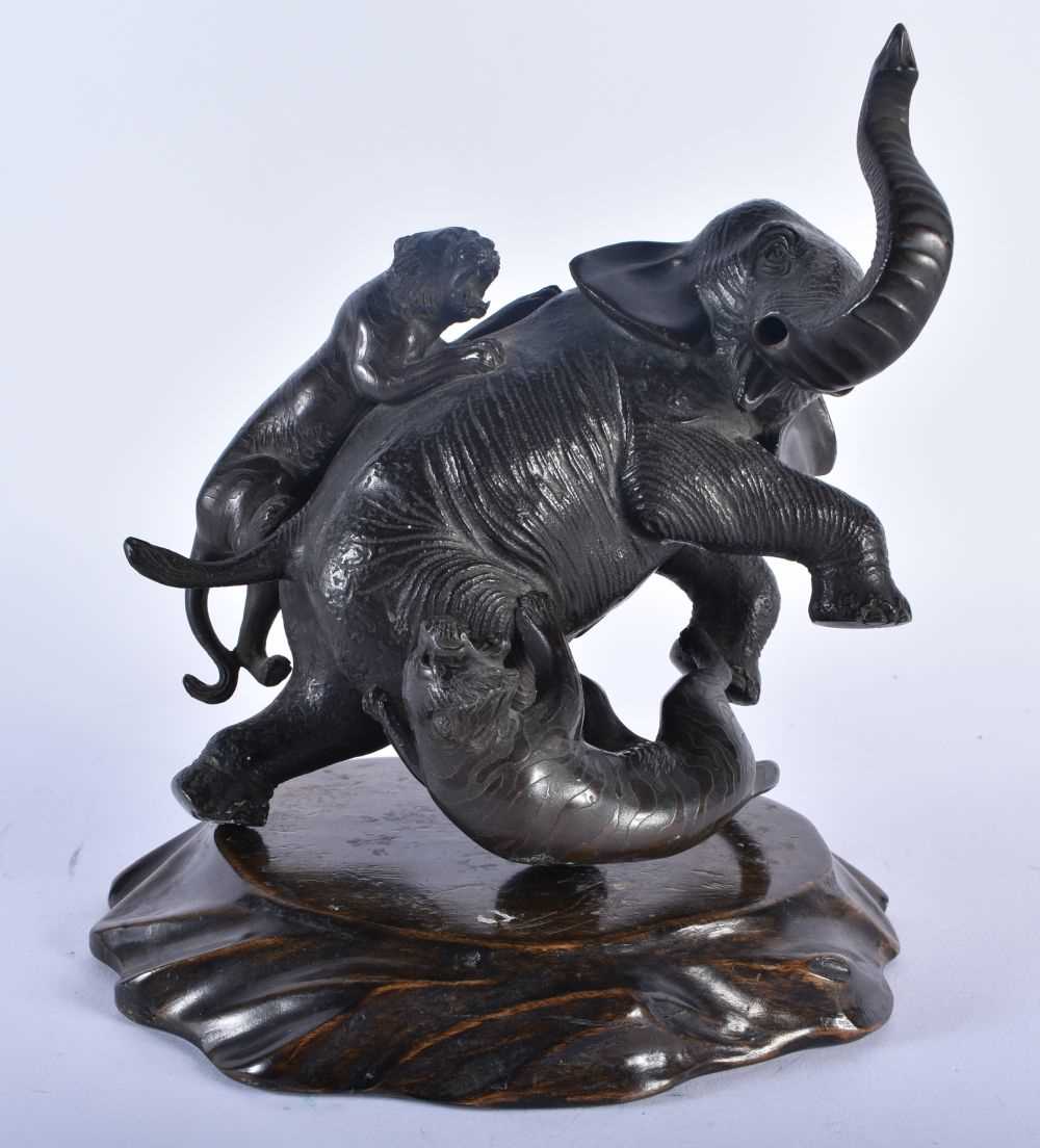 A 19TH CENTURY JAPANESE MEIJI PERIOD BRONZE OKIMONO modelled as an elephant being attacked by