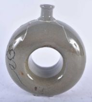 A KOREAN JOSEON DYNASTY CELADON DOUGHNUT FORM STONEWARE FLASK. 18cm x 14 cm.