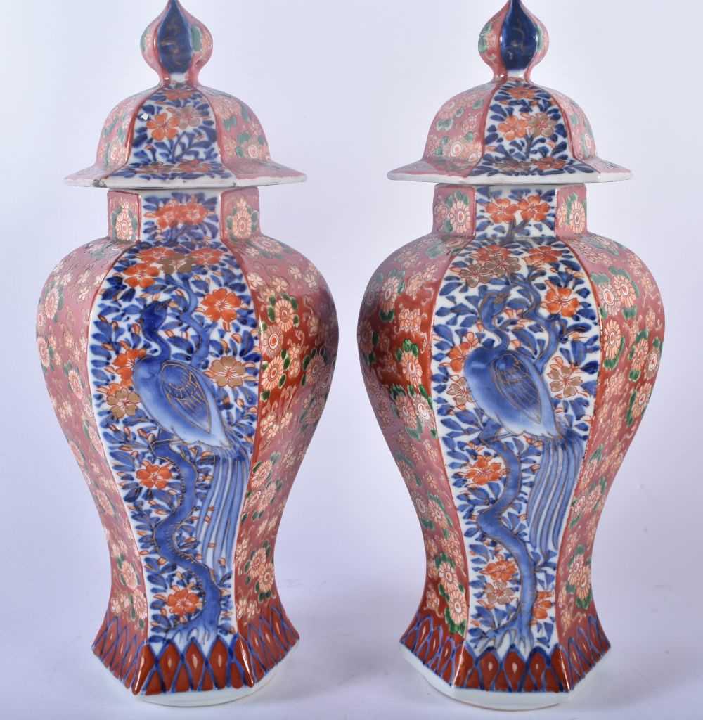 A PAIR OF 19TH CENTURY JAPANESE MEIJI PERIOD IMARI VASES AND COVERS painted with flowers, birds