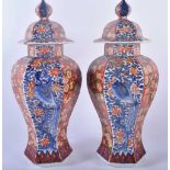 A PAIR OF 19TH CENTURY JAPANESE MEIJI PERIOD IMARI VASES AND COVERS painted with flowers, birds