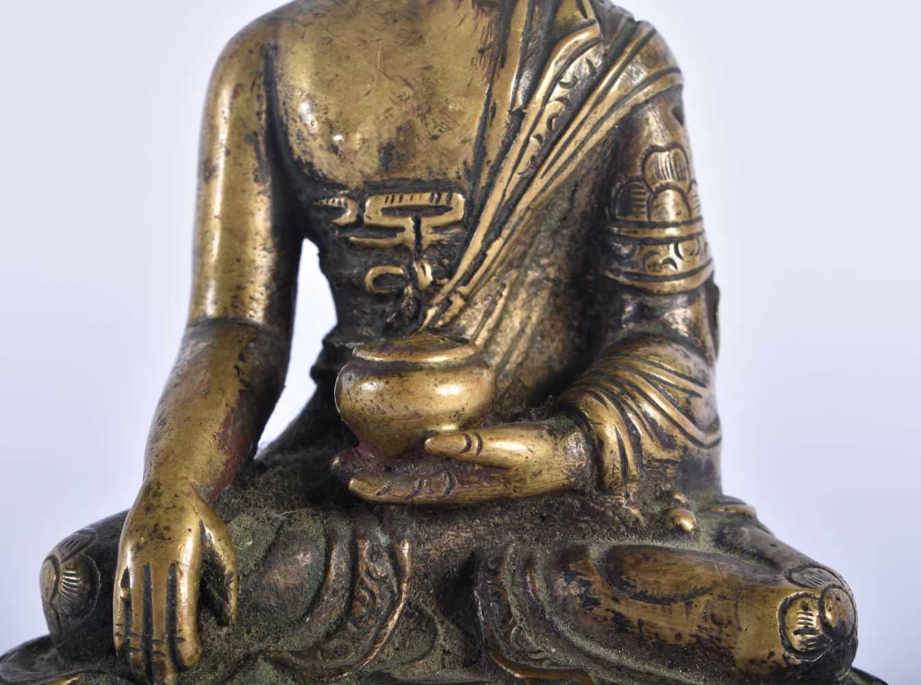 A 19TH CENTURY CHINESE BRONZE FIGURE OF A SEATED BUDDHA modelled upon a lotus capped base. 12 cm x 6 - Image 3 of 7