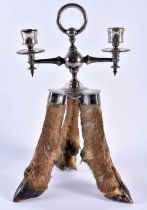 A RARE VICTORIAN TAXIDERMY ROWLAND WARD CANDLESTICK formed with three deer hooves. 32 cm x 16 cm.