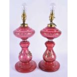 A Pair of Cranberry Glass Oil Lamp Bases converted to Electric Lights. 40cm to top of fitting,