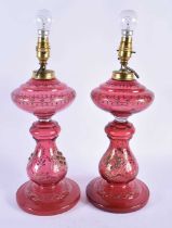 A Pair of Cranberry Glass Oil Lamp Bases converted to Electric Lights. 40cm to top of fitting,
