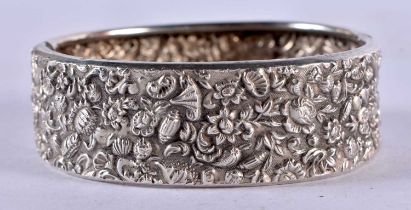 A Victorian White Metal Cuff Bangle with Embossed Decoration. Internal 5.5cm x 5cm, weight 23.7g