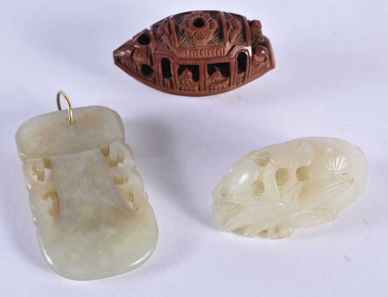 TWO CHINESE QING DYNASTY JADE CARVINGS together with a nut. Largest 5 cm x 3 cm. (3)