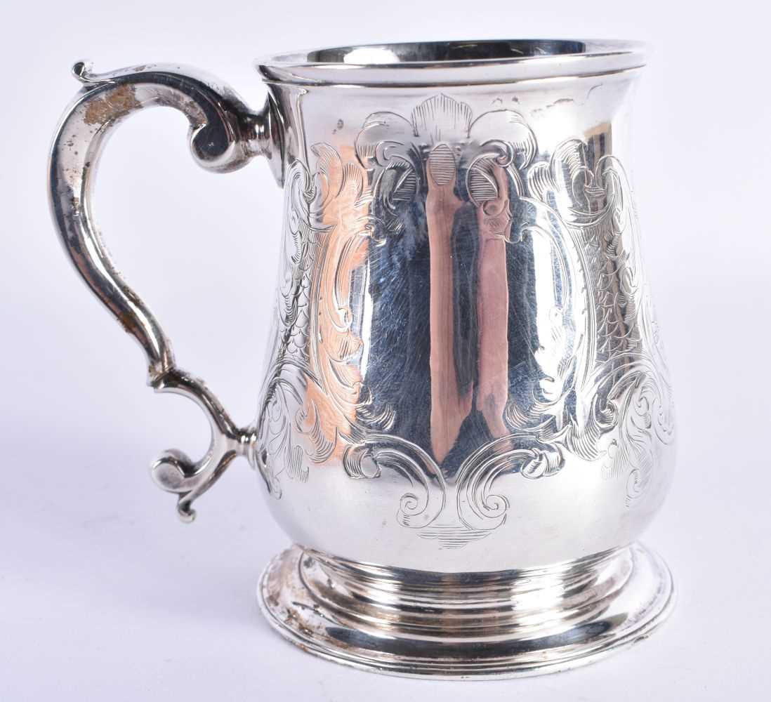 An Early Georgian Silver Tankard with Scroll Decoration and Vacant Cartouche. Hallmarked London