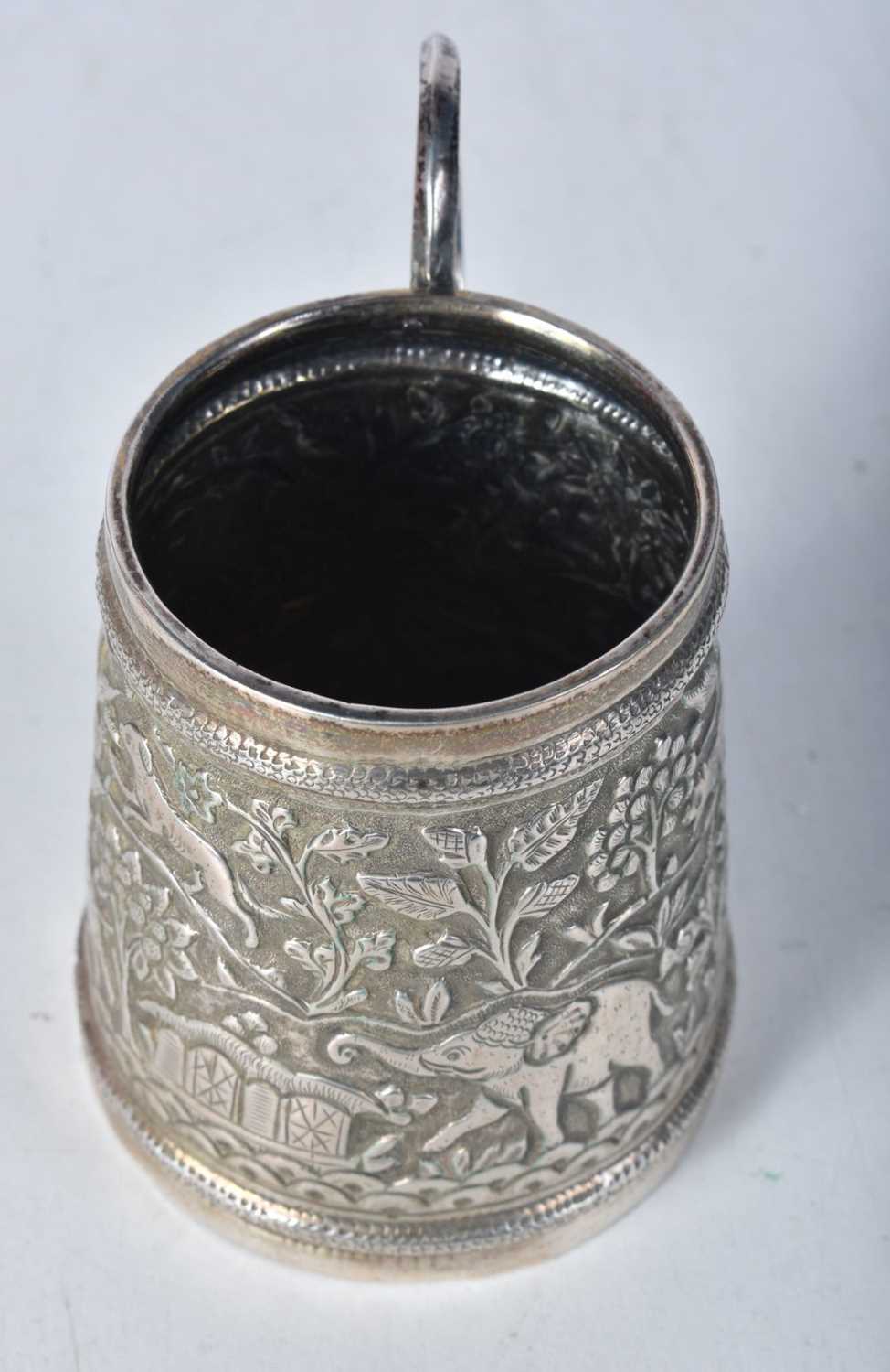 A White Metal Tankard with Embossed Jungle Scene. 8.3cm x 8.9cm x 6.2cm, weight 98g - Image 2 of 3