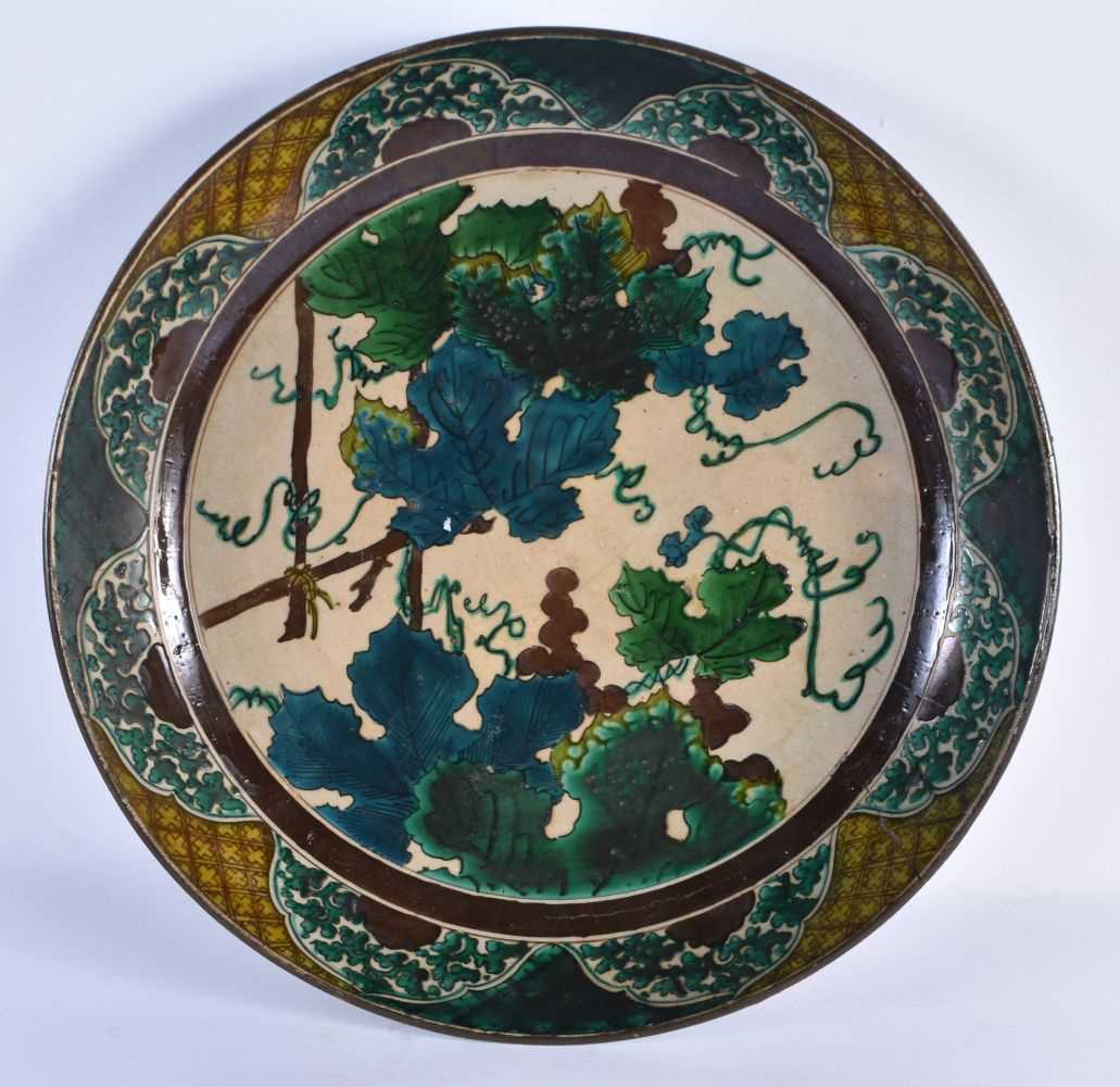 A LARGE 18TH CENTURY JAPANESE EDO PERIOD AO KUTANI DISH painted with flowers and landscapes. 37 cm