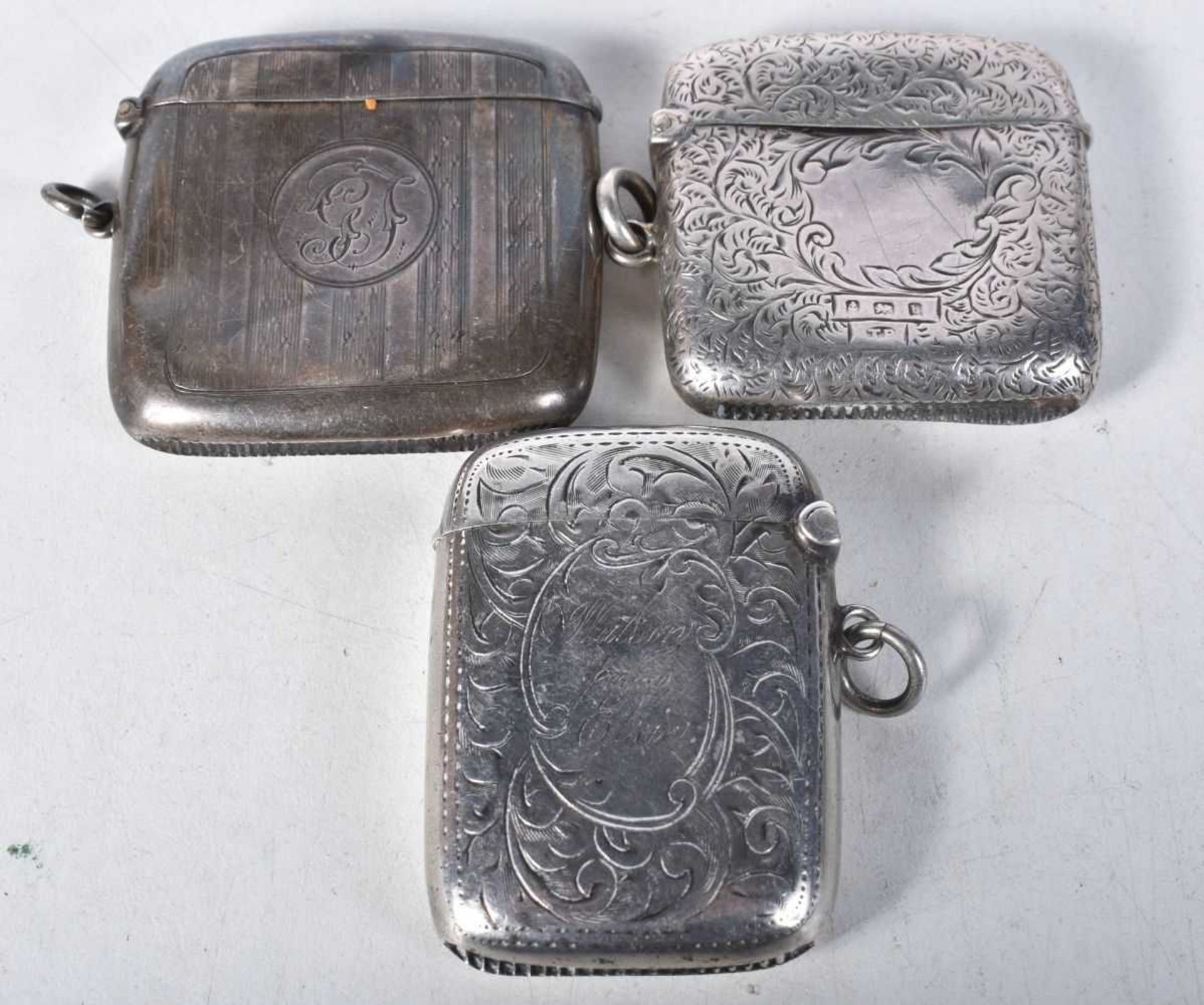 Three Engraved Silver Vesta Cases. Hallmarks include Birmingham 1913. Largest 5cm x 4.8cm x 1.2cm,