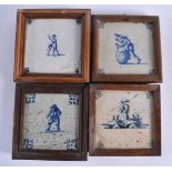 FOUR WOOD FRAMED DELFT BLUE AND WHITE TILES. 15 cm square. (4)