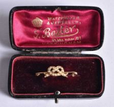 An Antique 9 Carat Gold Pearl Knot Bar Brooch in original fitted case. 3.2cm x 0.8cm, weight 0.8g.