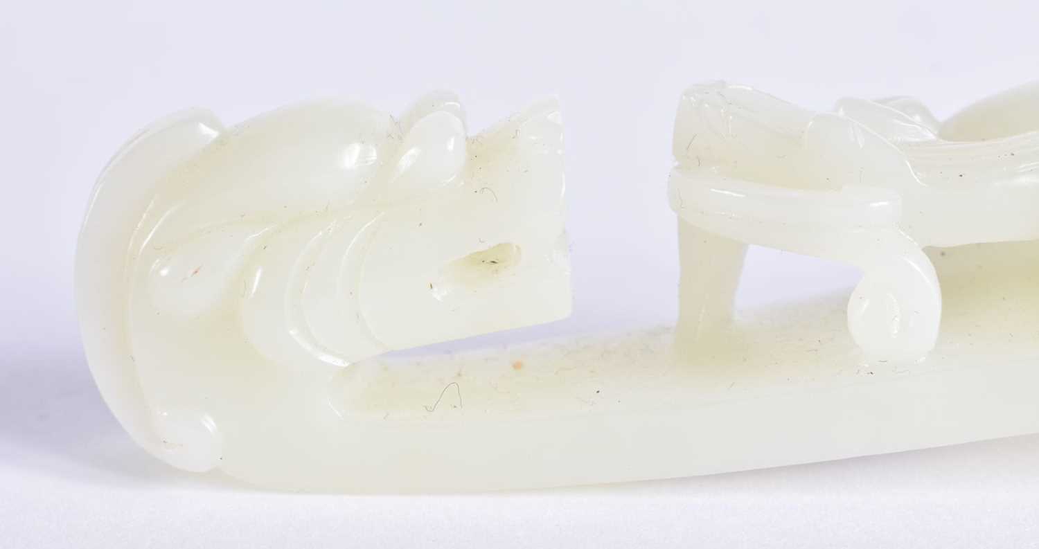 A FINE PAIR OF CHINESE QING DYNASTY CARVED GREENISH WHITE JADE BELT HOOKS Qing, formed as stylised - Image 9 of 30