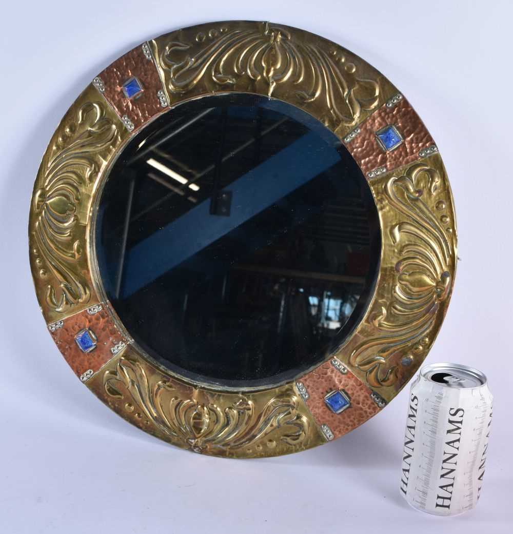 A LARGE ARTS AND CRAFTS COPPER AND BRASS REPOSSE MIRROR. 40 cm diameter.