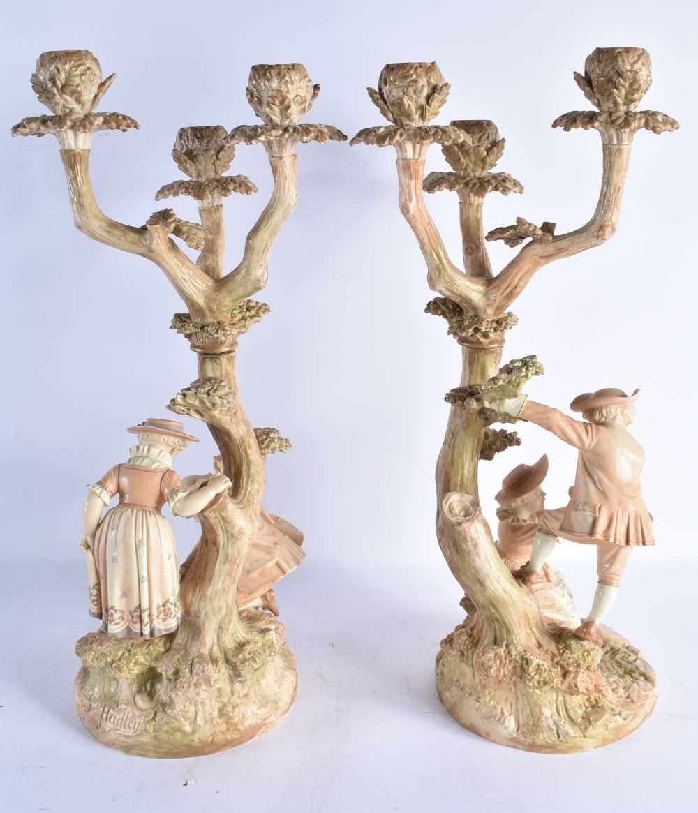 A RARE PAIR OF ROYAL WORCESTER HADLEYS BLUSH IVORY FIGURAL CANDLESTICKS modelled as children upon - Image 7 of 8