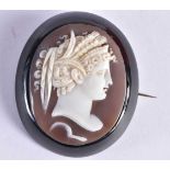 AN EARLY VICTORIAN CARVED JET AND CAMEO SHELL BROOCH. 14.8 grams. 5 cm x 4.25 cm.