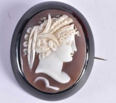 AN EARLY VICTORIAN CARVED JET AND CAMEO SHELL BROOCH. 14.8 grams. 5 cm x 4.25 cm.