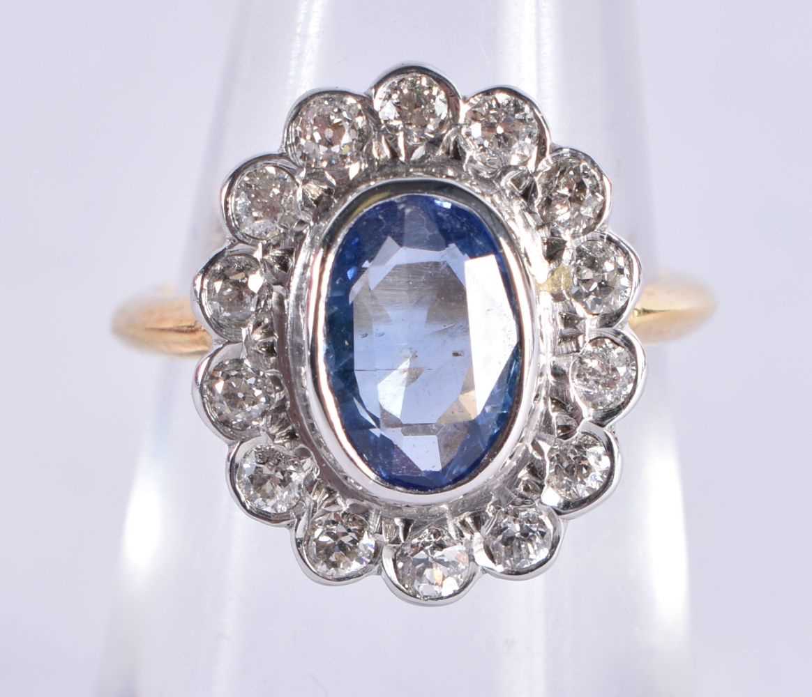 AN EDWARDIAN 18CT GOLD DIAMOND AND PALE SAPPHIRE RING. K. 4.6 grams.