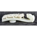 A FINE 17TH/18TH CENTURY CHINESE CARVED GREENISH WHITE JADE BELT HOOK Yongzheng, formed as a