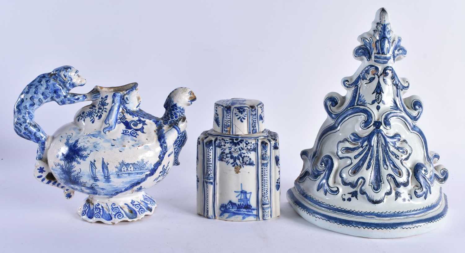 AN ANTIQUE DELFT FAIENCE WALL BRACKET together with a Delft figural monkey jug & a similar tea